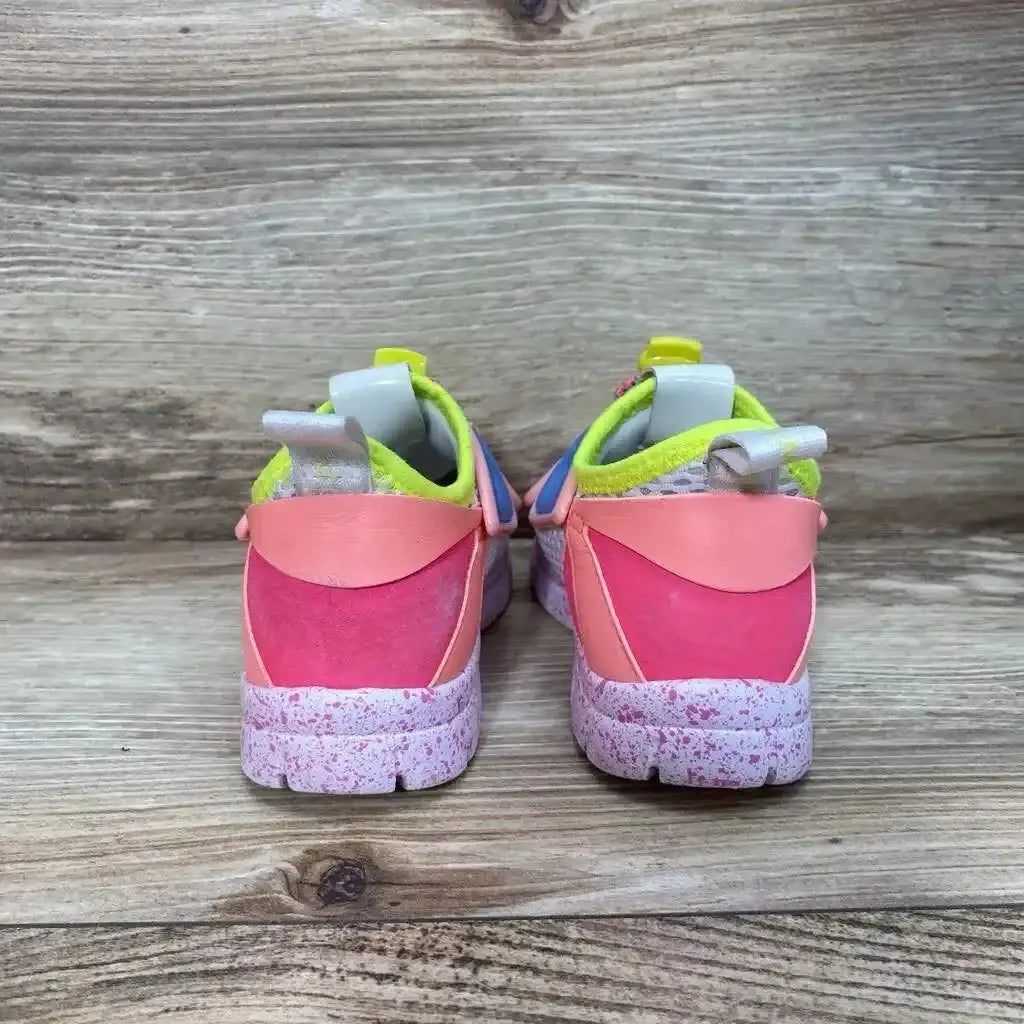 Back view of Sophia Webster Mini Chiara sneakers size 6C with pink heels, neon yellow lining, speckled sole on wood floor