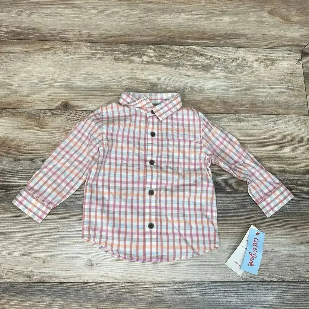 Flat lay of pink orange plaid Cat and Jack toddler button up shirt showing front buttons, chest pocket, and collar on wood floor