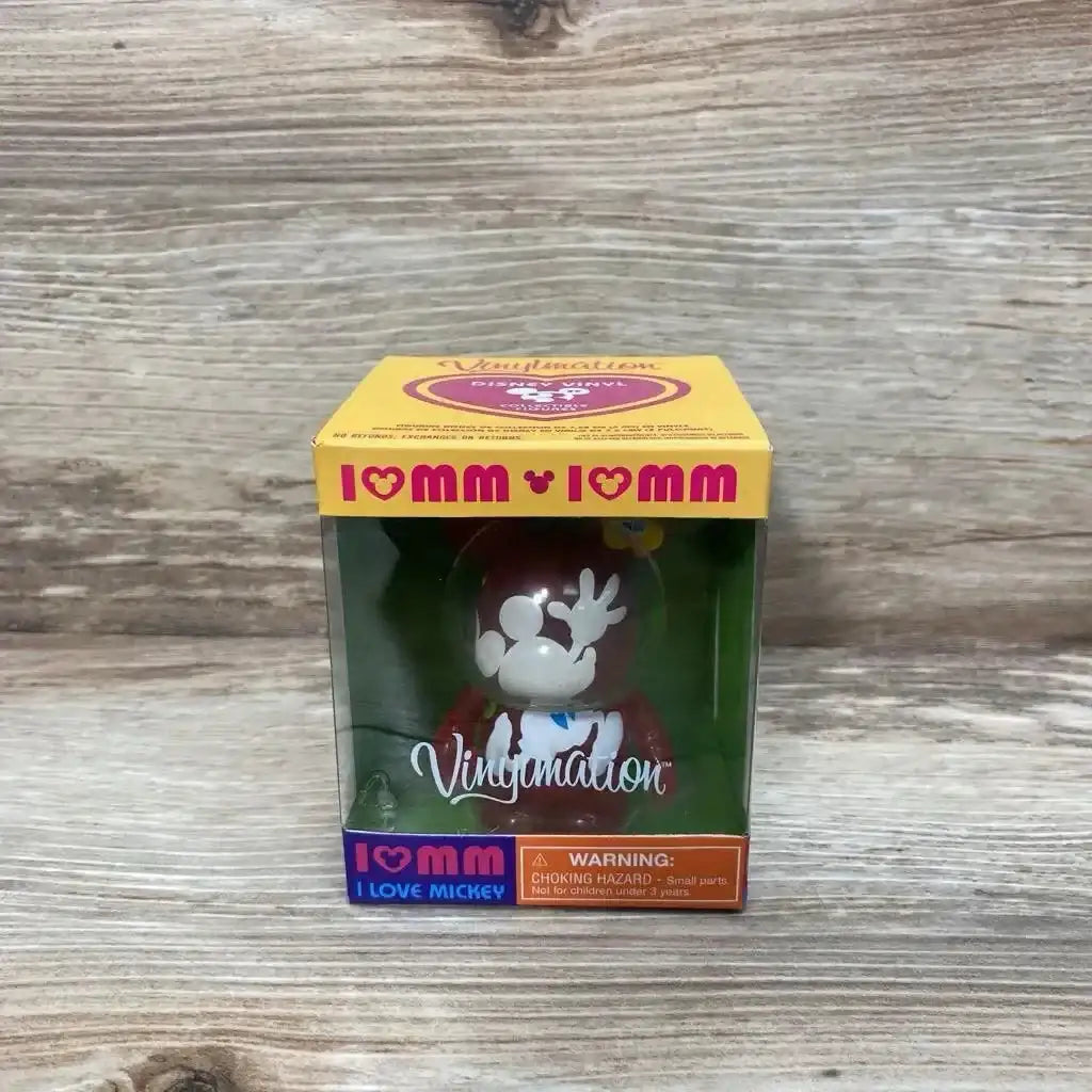 Front view of 3-inch Disney Vinylmation Love Mickey figure in original box showing red figure with white Mickey silhouette on a wood tabletop