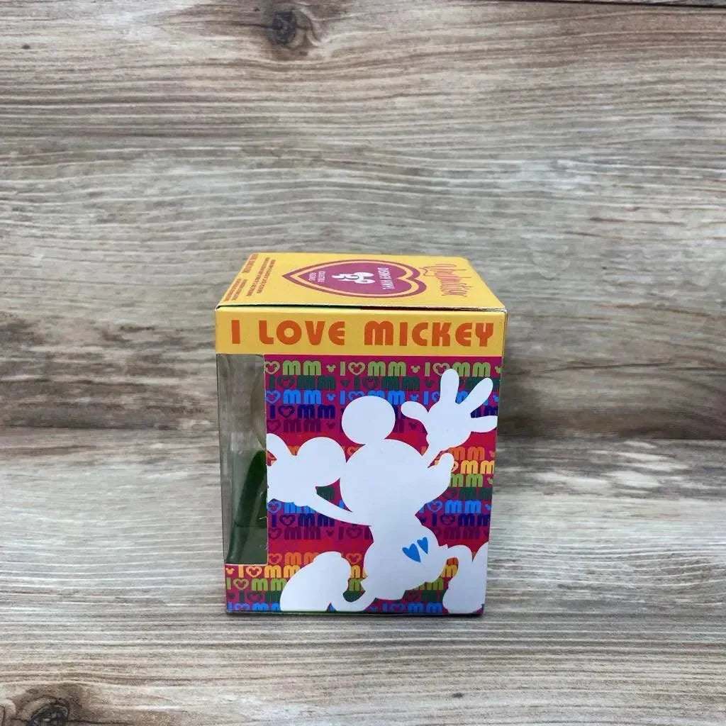 Front view of Disney Vinylmation 3-inch figure in boxed I Love Mickey packaging showing clear window and white Mickey silhouette on wood background