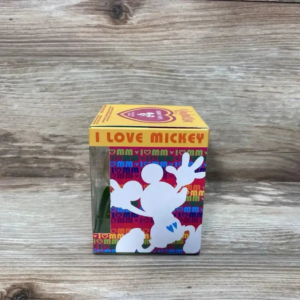 Front view of Disney Vinylmation 3-inch figure in boxed I Love Mickey packaging showing clear window and white Mickey silhouette on wood background