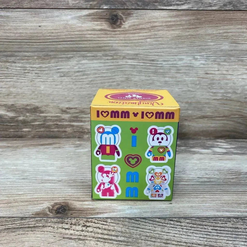 Front view of Disney Vinylmation Love Mickey 3in boxed figure with green panel showing four Mickey designs on wood background