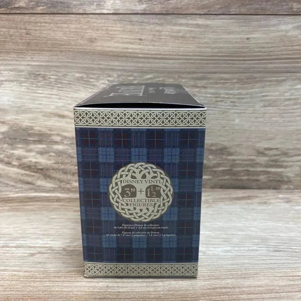 Front of Vinylmation Disney Brave 4pc set box showing tartan panel and Disney Vinyl logo on wood background