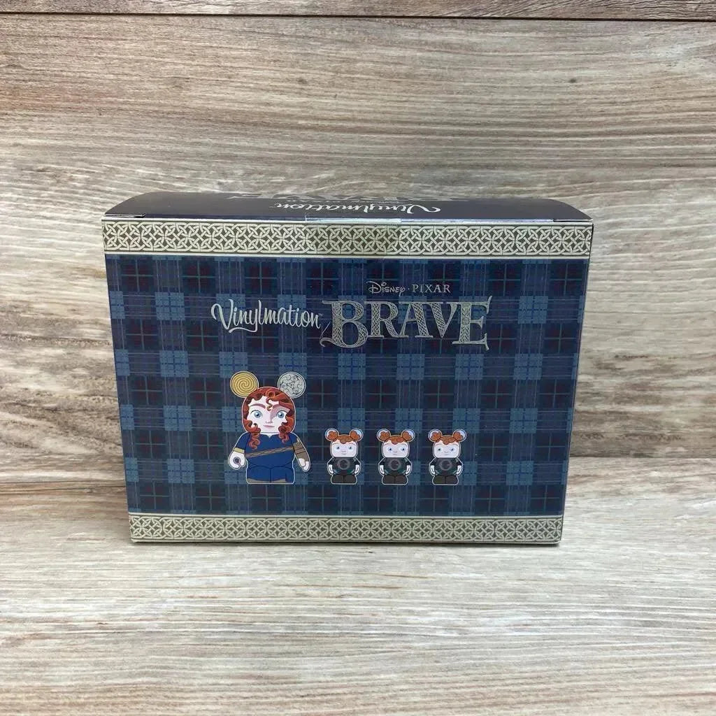 Front view of Vinylmation Brave 4-piece box with tartan design and Merida plus three bear figures on wood