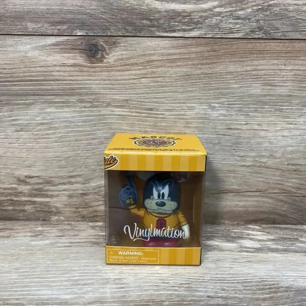 Front view of 3-inch Disney Vinylmation Goofy figure in yellow Mascot Series window box showing figure with foam finger against wood backdrop