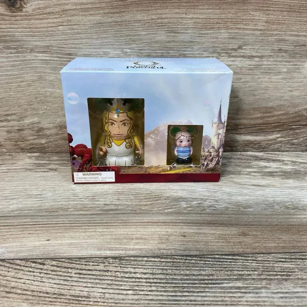 Front view of two Vinylmation Oz the Great and Powerful figures, 3-inch and 1.5-inch, in original window box on wood tabletop