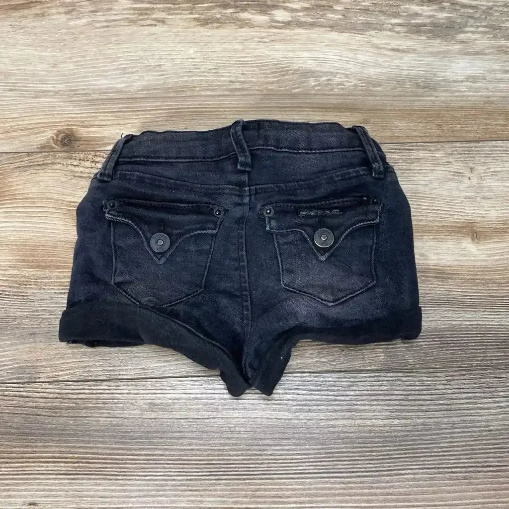 Front view of Hudson Rolled Hem Shorts sz 24m showcasing black fabric, rolled hems, and flap pockets on a wood-grain background