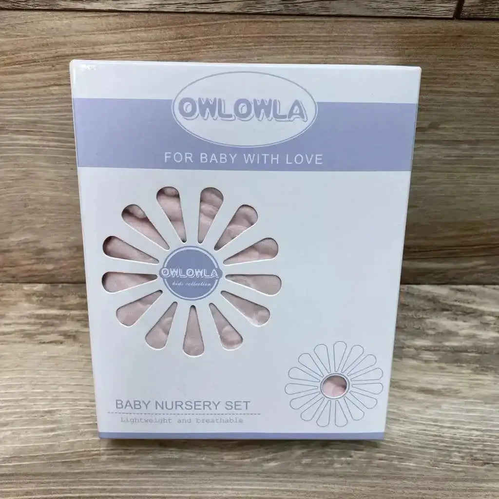 Front view of Owlowla nursing pillow cover showing pink minky dot fabric through flower-shaped cutouts on a wood tabletop