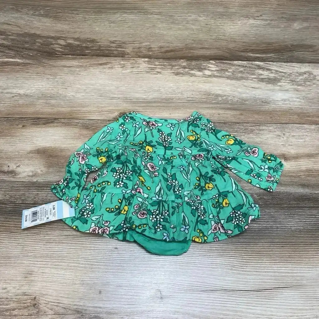 Top-down of green Cat & Jack floral henley dress and bloomers showcasing long sleeves and tiered ruffle skirt on wood background with size tag