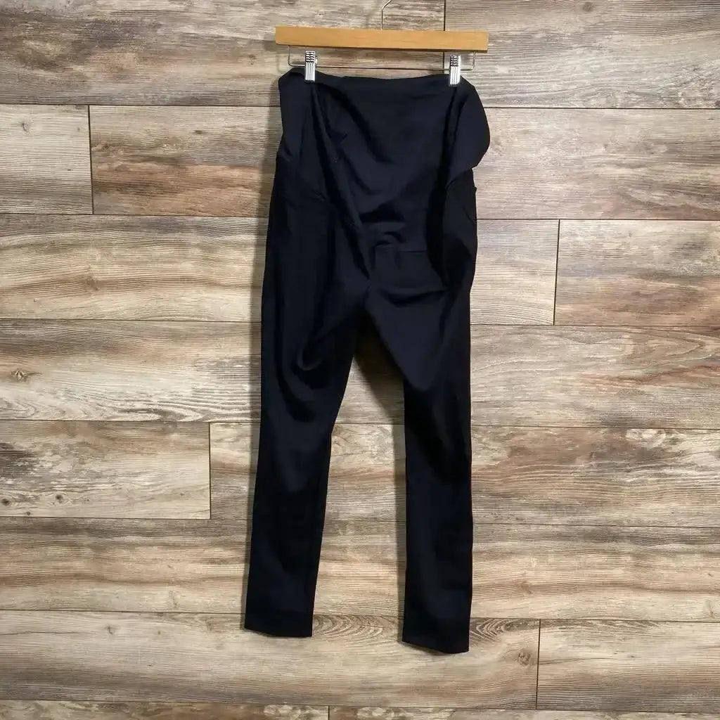 Front view of black Isabel maternity crossover-panel pants showcasing the crossover belly panel and straight legs on a white background