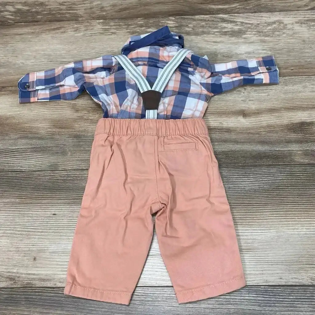 Flat lay of baby plaid button-up suspender set showing blue and peach plaid shirt with white-striped suspenders and elastic-waist peach pants on wood background