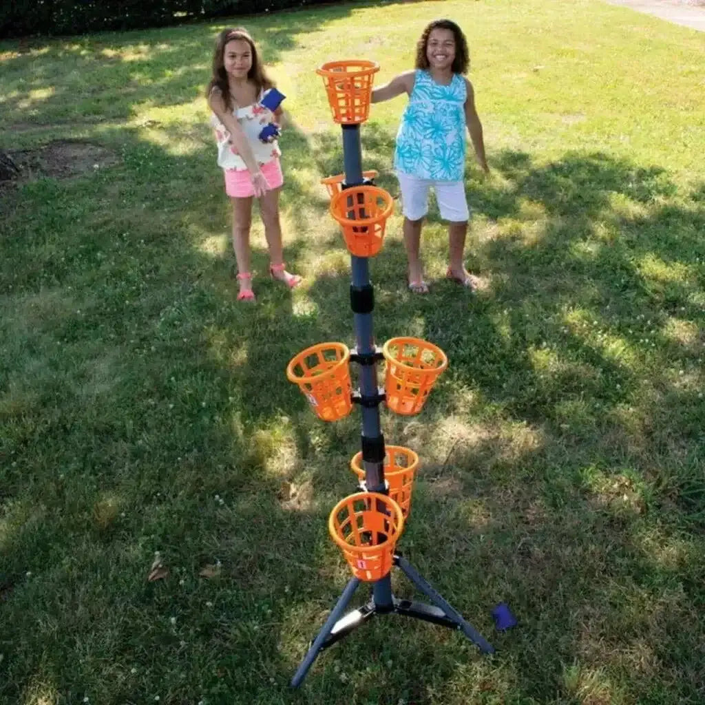 Angled view of B3 Bean Bag Bucketz game with six orange baskets on a tripod stand and children playing in a grassy yard