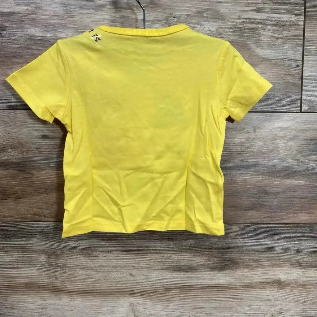Back view of Children's Place yellow toddler t-shirt 12-18M showcasing plain back and short sleeves with wood floor background