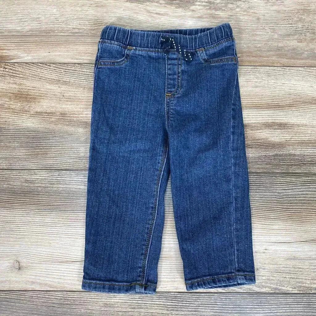 Flat lay of Jumping Beans straight-fit jeans size 18m with elastic waist, dotted drawstring, straight legs on light wood