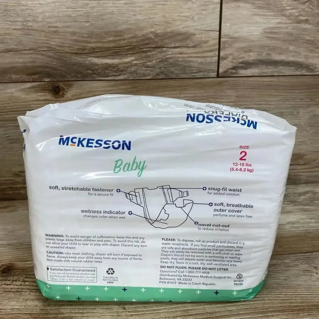 Front of McKesson disposable diapers, size 2 (12-18 lbs), showing moderate absorbency and wetness indicator on wood