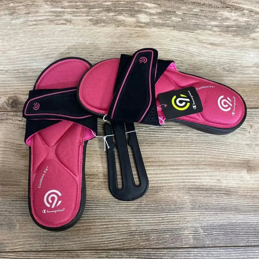 Top view of pink and black C9 Valma Sport slide sandals with memory-foam cushioned footbed and adjustable strap on wood floor