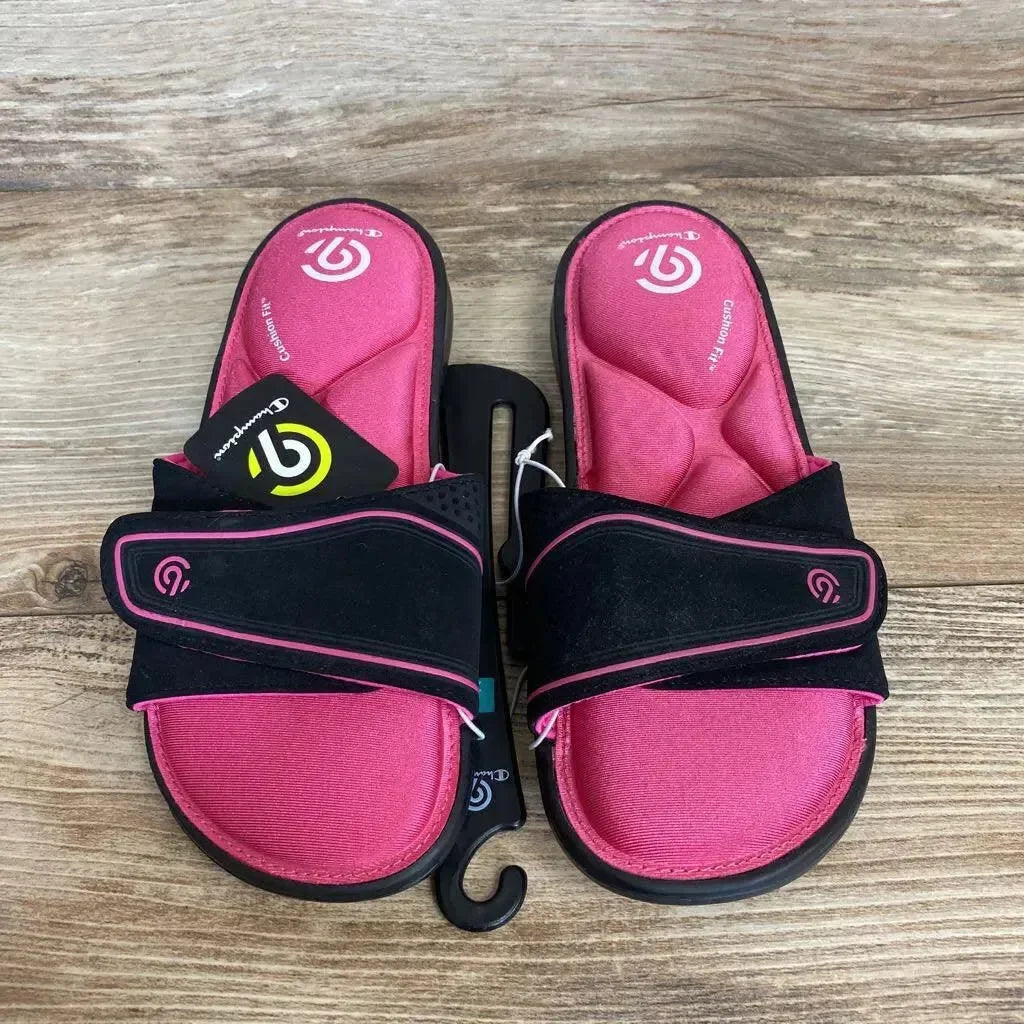 Top view of C9 Valma memory foam slide sandals showing pink contoured footbeds and black adjustable Velcro straps on wood background