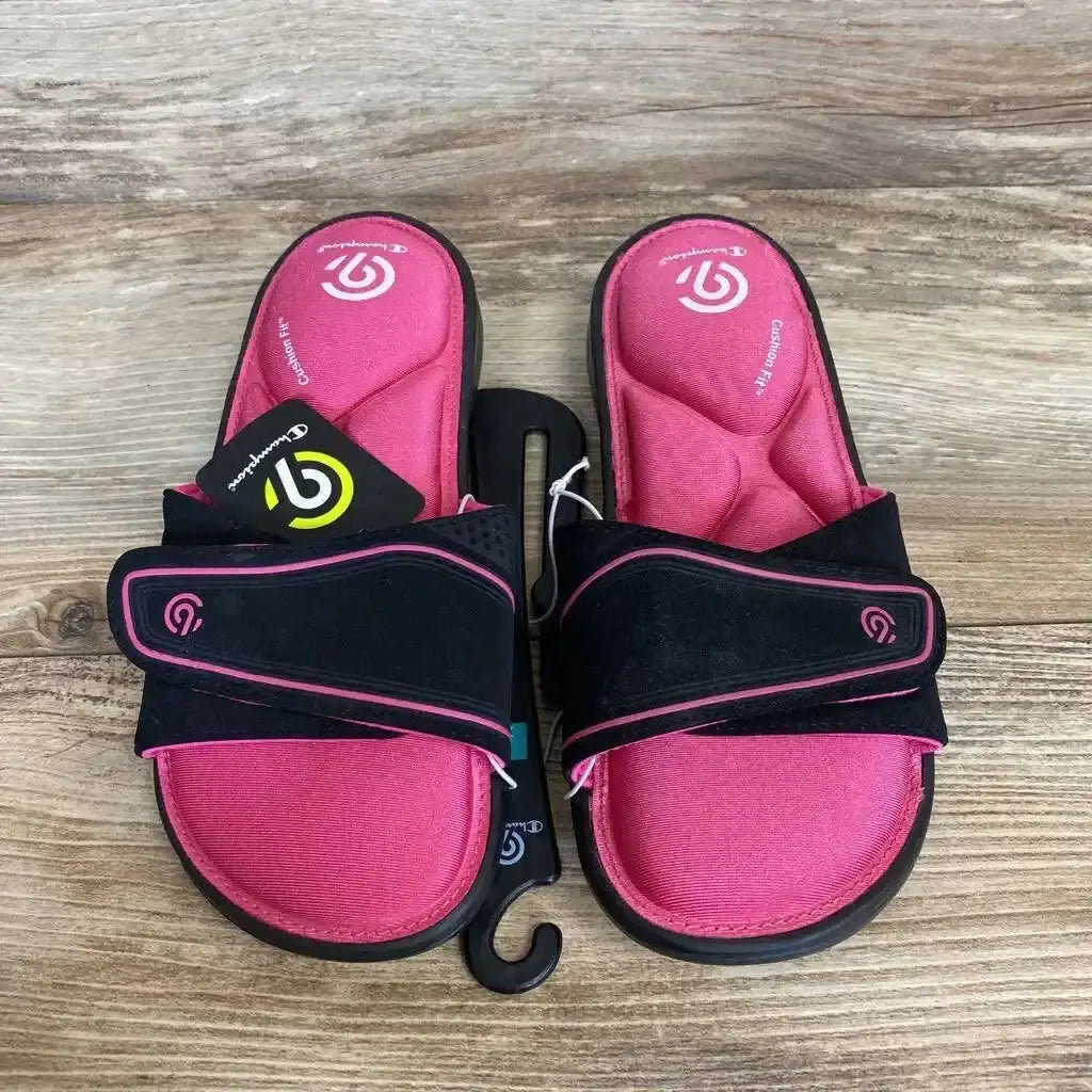 Top view of C9 Valma memory foam slide sandals showing pink contoured footbeds and black adjustable Velcro straps on wood background
