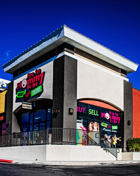 Me ‘n Mommy To Be storefront with pink logo and large ‘BUY SELL’ window signs and children’s clothing visible inside