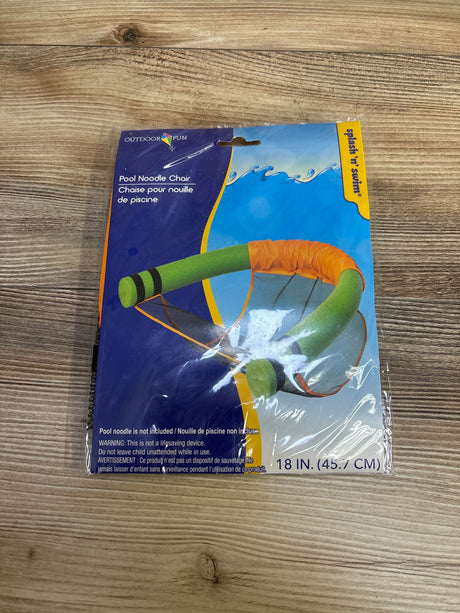 Top-down view of pool noodle chair package showing green noodle frame, orange mesh seat, and printed size 18 in (45.7 cm) on wooden table