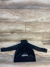 Back view of black Adidas full-zip toddler jacket size 18mo showing white sleeve stripes and embroidered logo on wood background