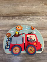 Top view of Classic World fire engine busy board with sliding ladder, bead maze, spinning gear, bell on wood surface