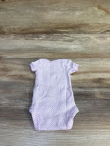 Flat lay of preemie Child of Mine Happy bodysuit showing short sleeves and light purple dot print on wood background
