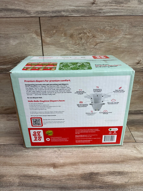 Back view of Hello Bello Premium Diapers Size 1 82ct showing premium diapers for premium comfort on wood background