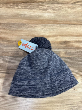 gray knit winter hat with pom pom on wooden surface, tag reading Cat & Jack
