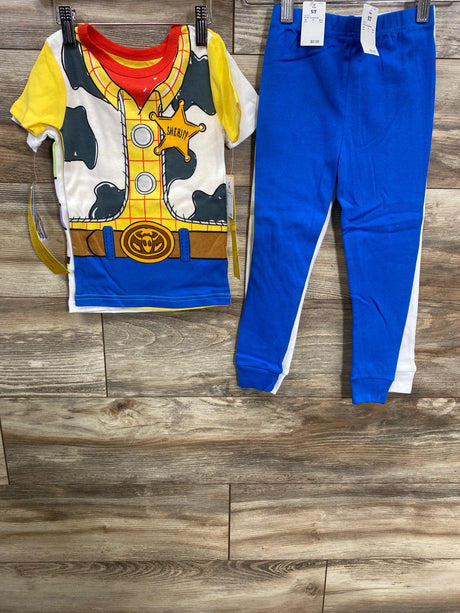 Children's blue and white Sheriff-themed cowboy outfit with yellow accents and matching blue pants on wooden floor
