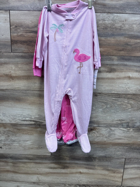 Front view of two baby footed sleepers, pink striped sleeper with flamingo embroidery and solid pink sleeper on wood background