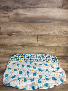 Blue and yellow whale and fish patterned baby changing pad on wooden floor
