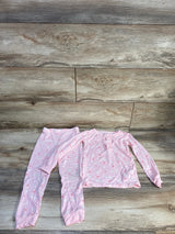 Flat lay of pink 2-piece swan-print toddler pajama set (4T) showing ruffled neckline and elastic-waist pants on wood floor