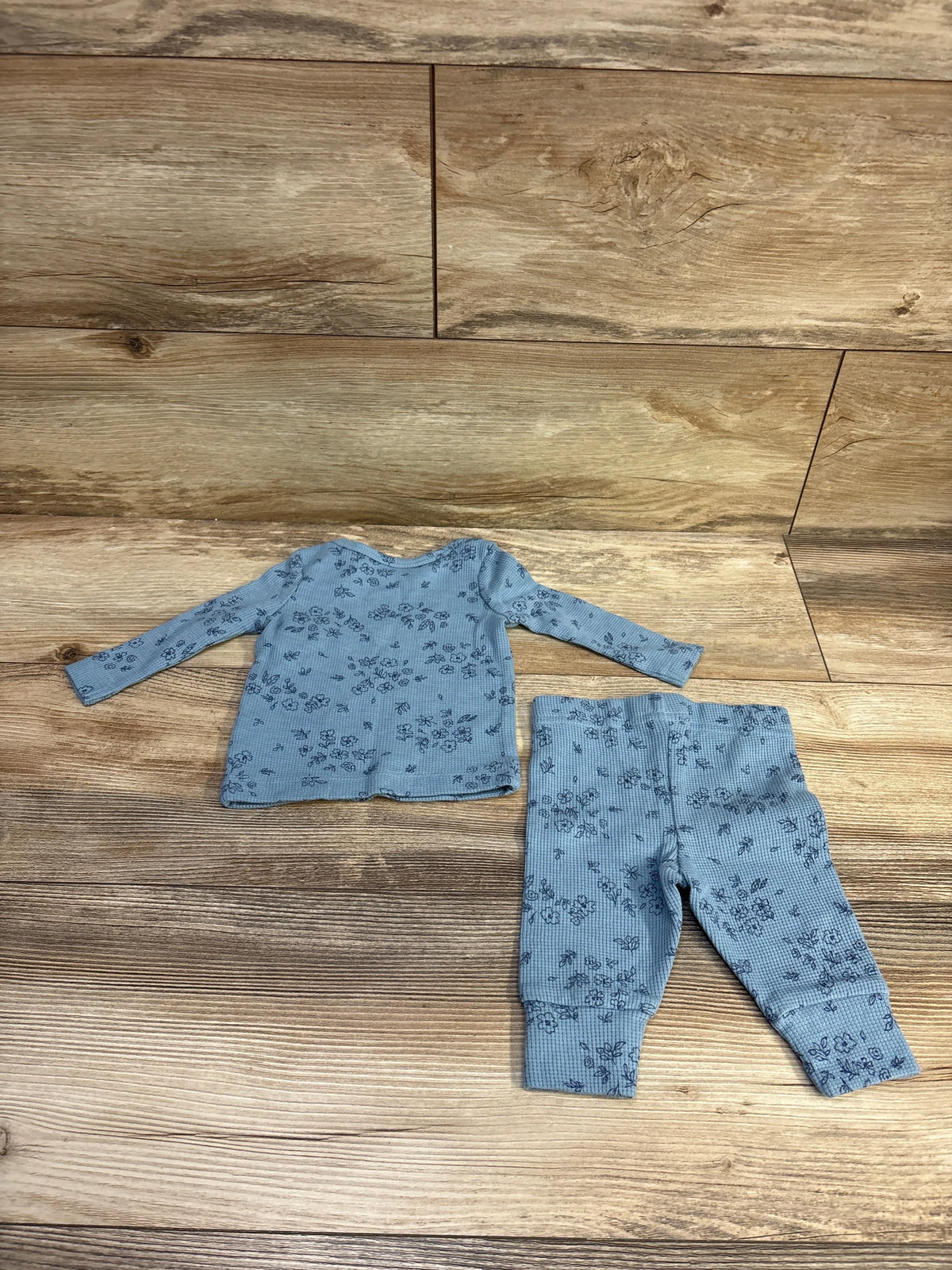 Just One You 2pc blue waffle knit shirt and pants set with floral print on a wooden background