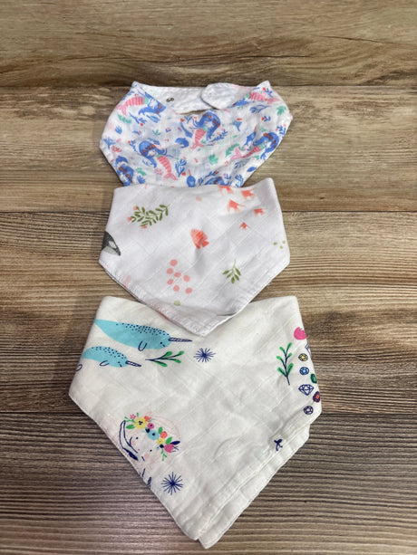 Top view of Angel Dear 3-pack white bandana bibs showcasing three colorful patterns and snap closures on a wood surface