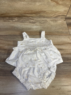 Top view of Baby Gap white 2pc Birthday Cake outfit ruffle tank and bloomers with gold cake print on wood floor
