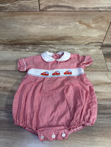 Top down view of red gingham baby bubble romper with white Peter Pan collar and smocked firetruck embroidery on wood floor