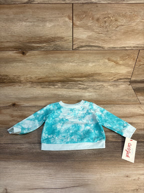 Blue and white tie-dye long sleeve baby sweatshirt on wooden background with tag