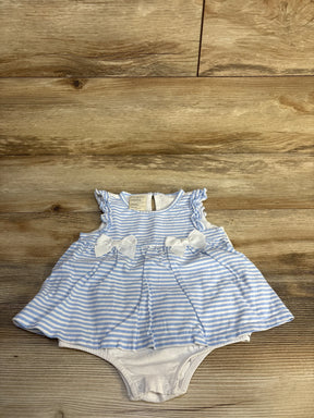 Flat-lay of blue and white striped baby bodysuit dress showcasing ruffle cap sleeves, two front bows, gathered skirt and snap-closure crotch on wood background