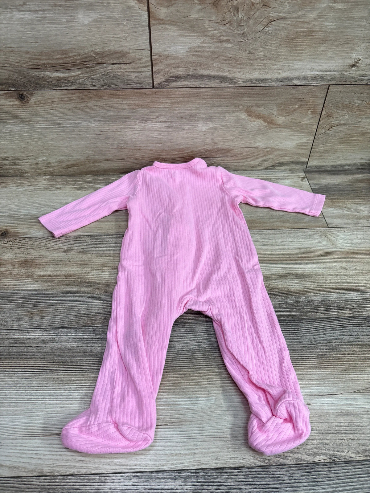 Top view of Little Me pink ribbed sleeper, size 9m, with long sleeves and enclosed feet on wood-grain background