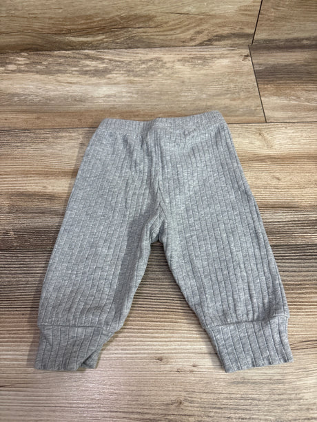Front view of gray Shein drawstring joggers for 1 to 3 months showcasing ribbed fabric and cuffed ankles on a wood floor