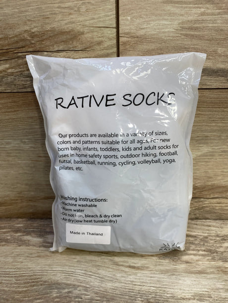 Front view of New Rative non-slip baby crew socks 12-pack in bag showing 'RATIVE SOCKS' and 'Made in Thailand' on wood