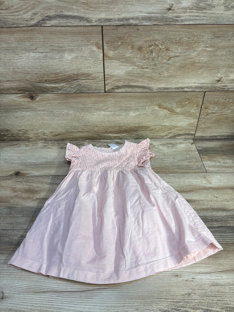 Top-down view of pink eyelet toddler dress 18 months showing eyelet bodice and flutter sleeves on wood floor background