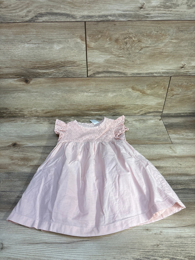 Top-down view of pink eyelet toddler dress 18 months showing eyelet bodice and flutter sleeves on wood floor background