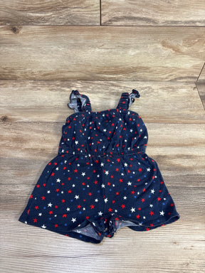 Flat lay of navy Old Navy sleeveless baby romper showcasing red, white, and blue star print and snap crotch on wood floor
