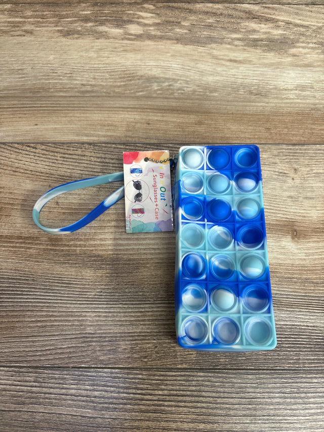 Blue and white rectangular silicone pop-it toy keychain with attached colorful sunglasses case tag on wood surface