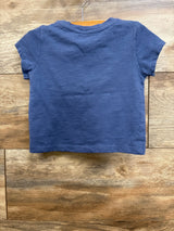 Back view of Roxy floral toddler shirt showcasing short sleeves and crew neckline with slub knit texture on wooden background
