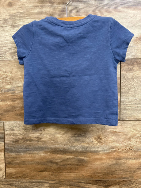 Back view of Roxy floral toddler shirt showcasing short sleeves and crew neckline with slub knit texture on wooden background