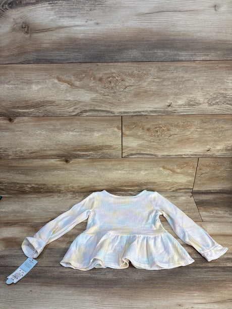 Long sleeve pastel tie-dye toddler shirt with ruffled hem on wooden background