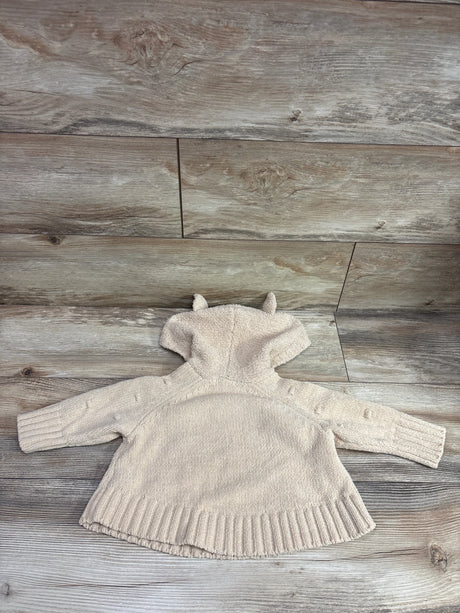 Tan Cat & Jack hooded dot sweater for baby size 12-18m on a wood background